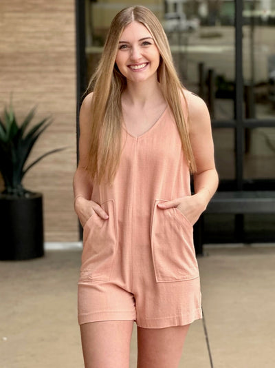 Lexi in tropical peach romper front view hands in pockets