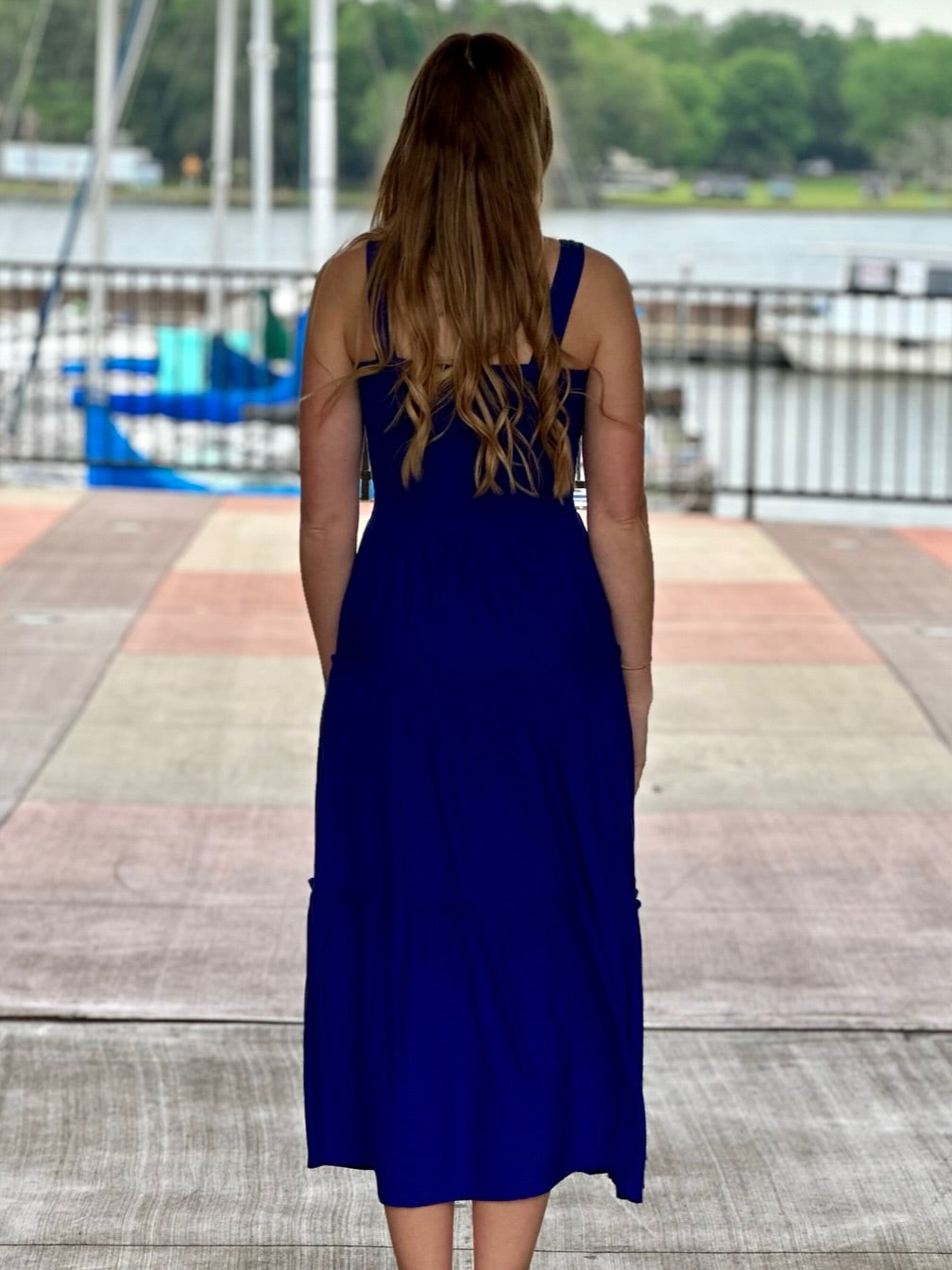 Lexi in bright blue midi dress back view