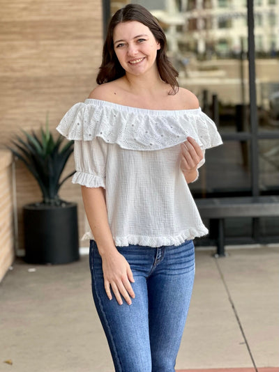 Megan in off white blouse holding blouse