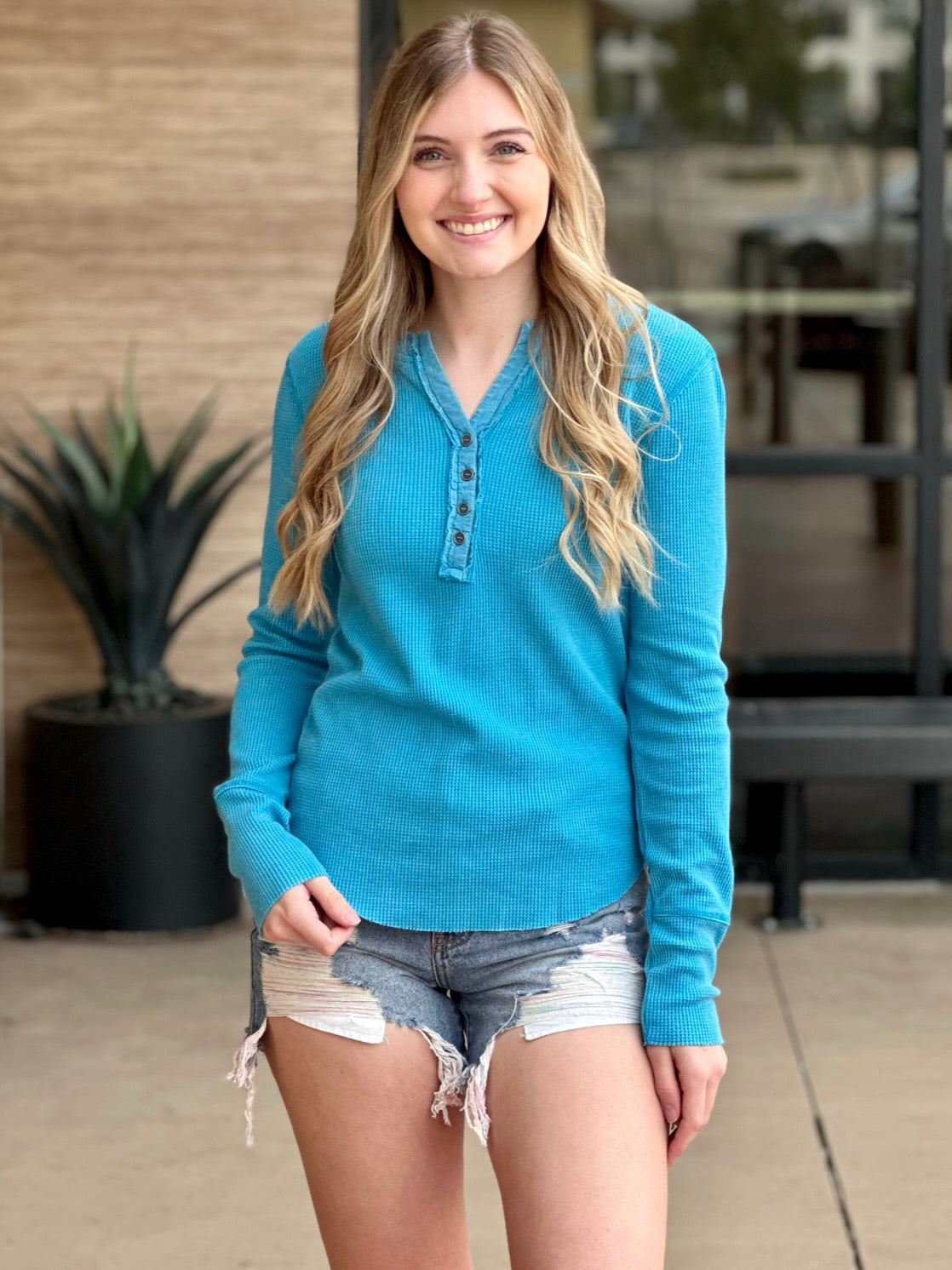 Lexi in turquoise henley front view smiling