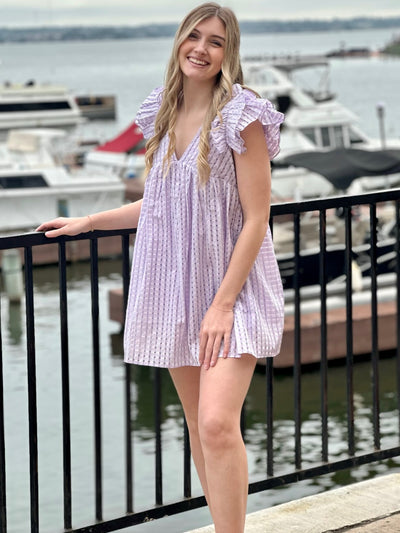 Lexie in lavender dress front view hand on ledge