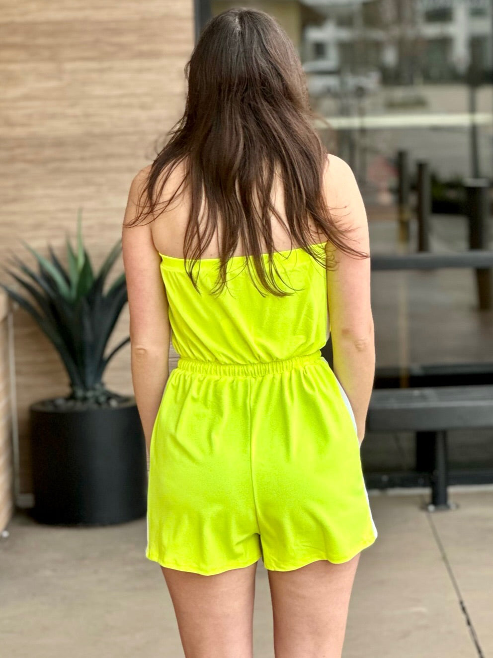 Megan in yellow jumpsuit back view