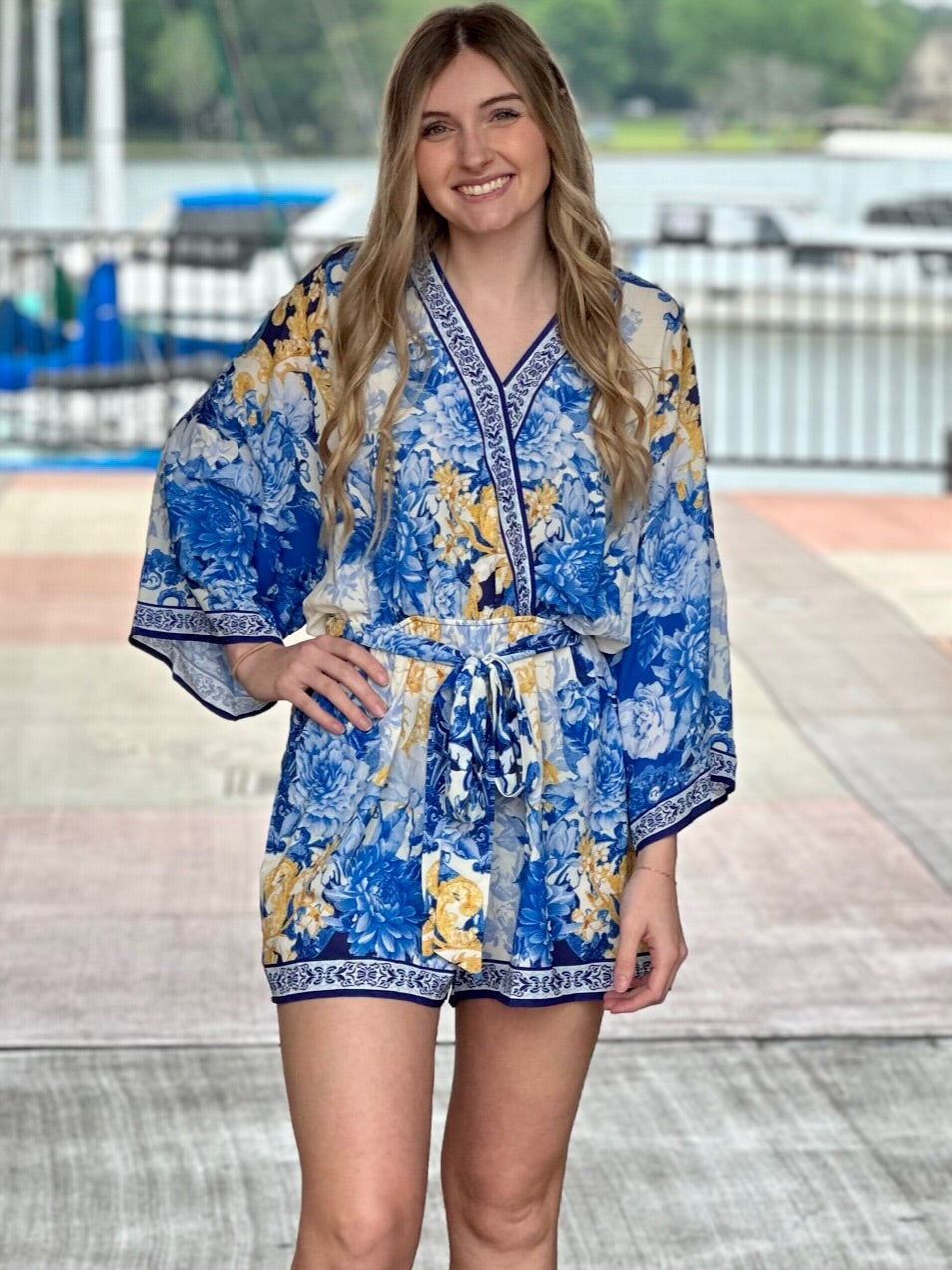 Lexi in blue romper hand down