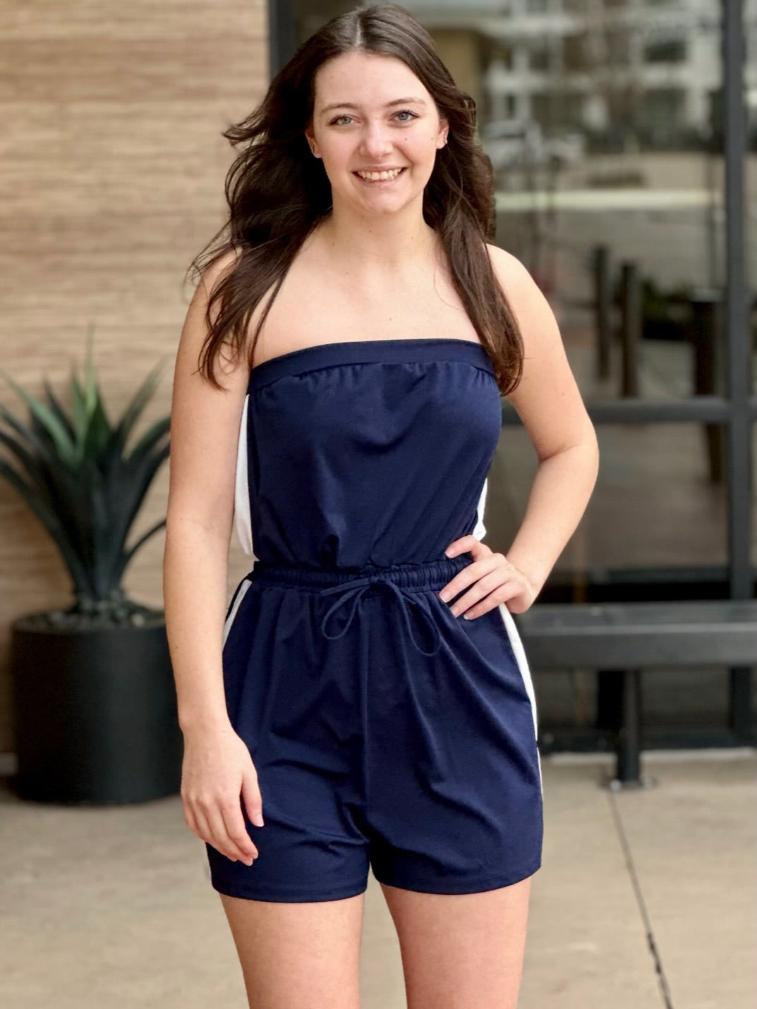 Megan in navy jumpsuit smiling front view