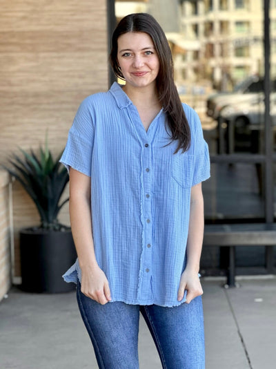 Megan in spring blue shirt front view holding shirt