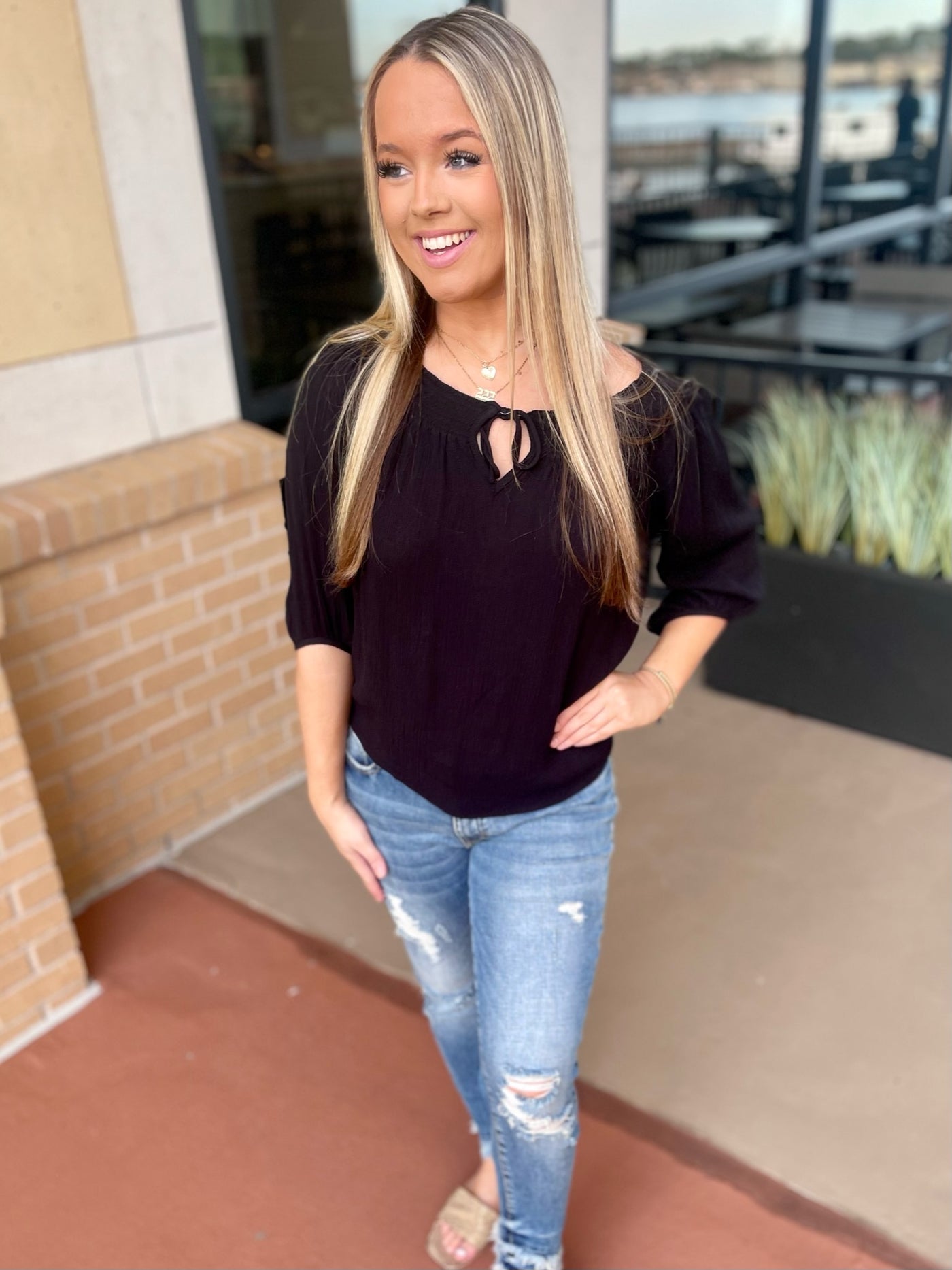girl wearing black top and jeans
