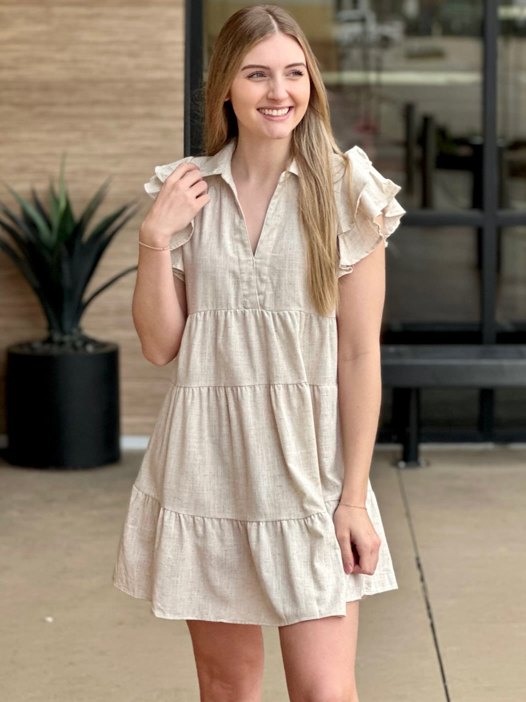 Lexi in oatmeal dress hand on shoulder