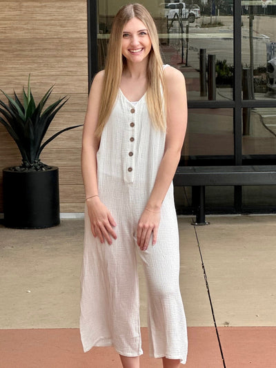 Lexi in off white jumpsuit front view smiling hands down
