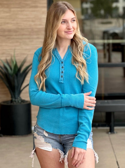 Lexi in turquoise henley front view looking to the side