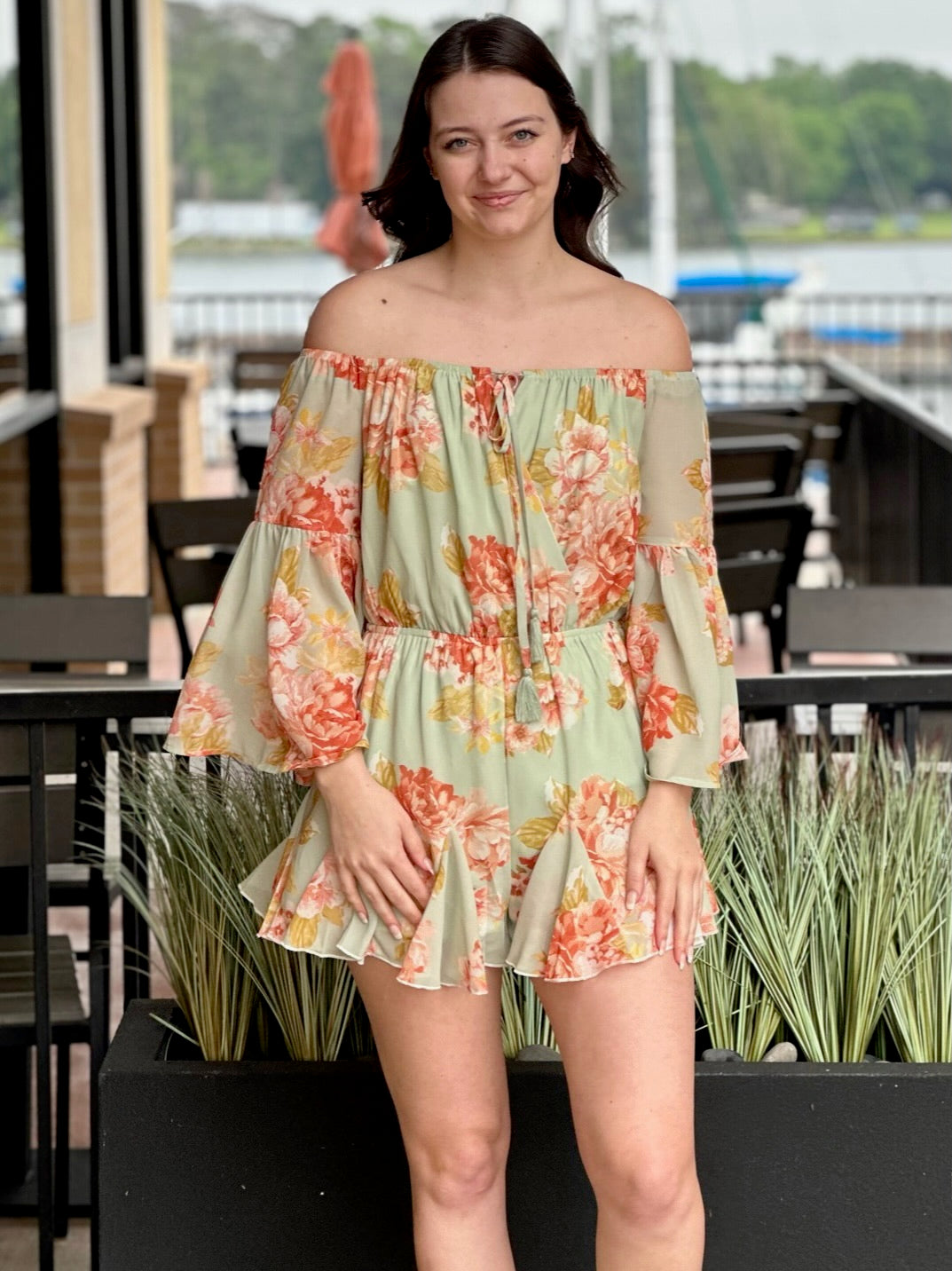 Megan in sage romper smiling