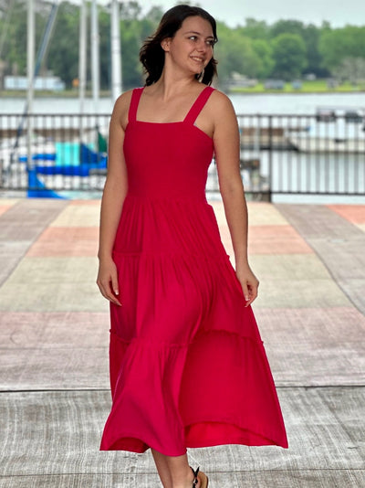 Megan in hot pink midi dress looking to the side