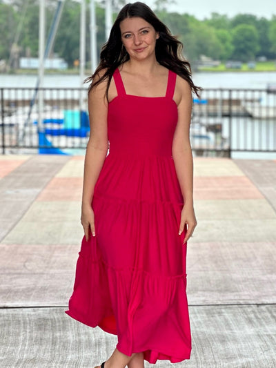 Megan in hot pink midi dress front view hands down soft smile