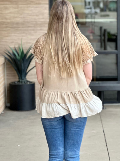 Megan in taupe top back view