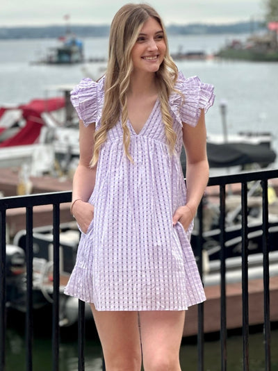 Lexie in lavender dress looking to the side