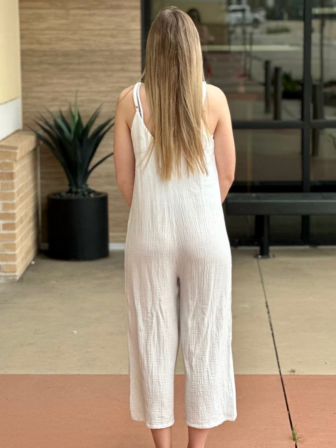 Lexi in off white jumpsuit back view