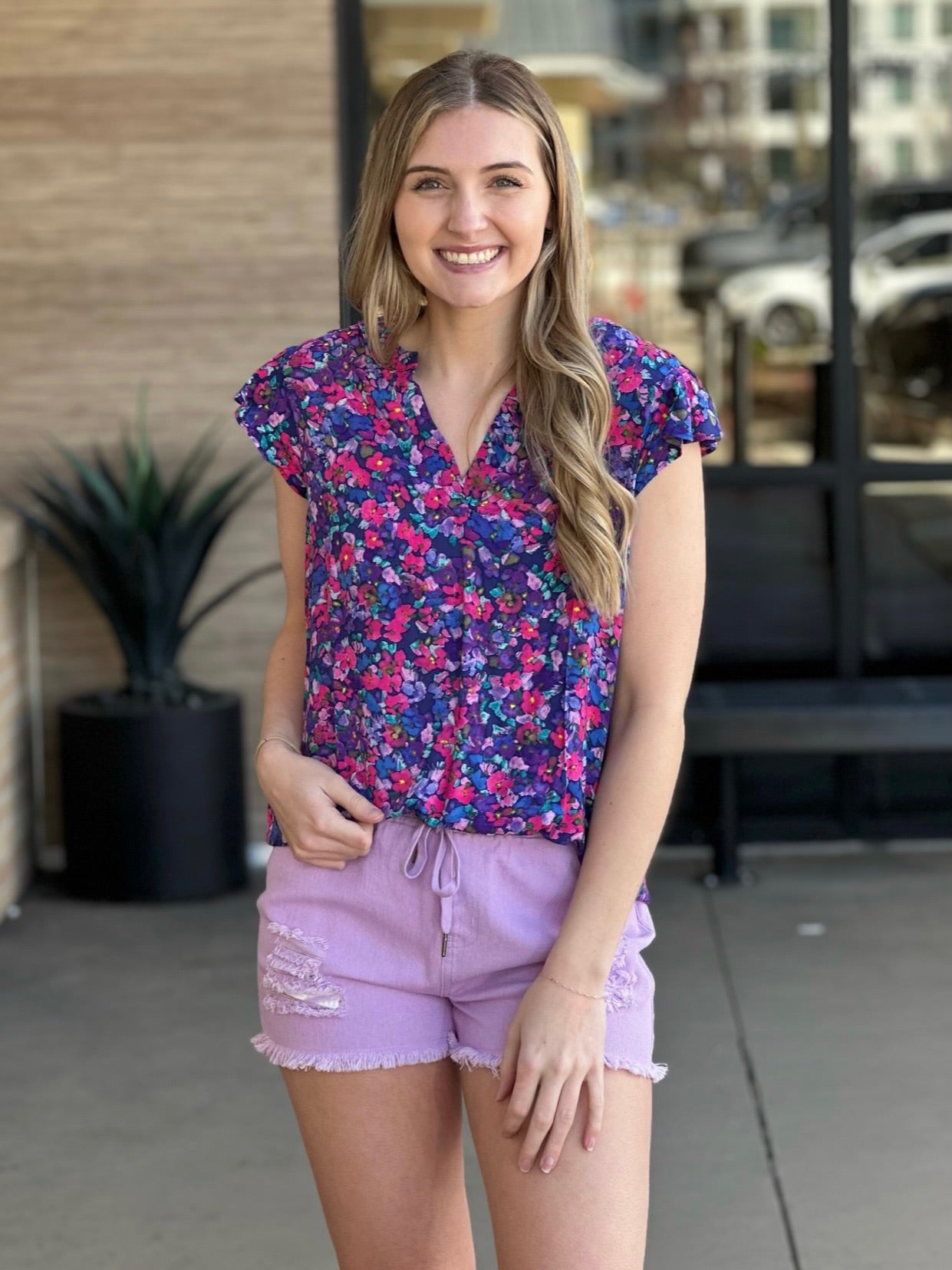 Lexi in multi blouse front view smiling
